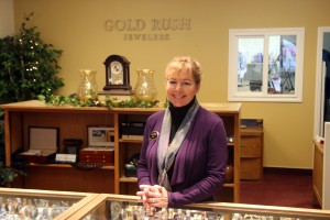 Woman standing smiling at Gold Rush Jewelers in Petaluma, CA.